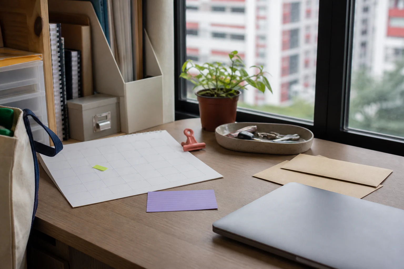A Singapore HDB study corner with a blank calendar, key tray, envelopes and coloured reminder markers
